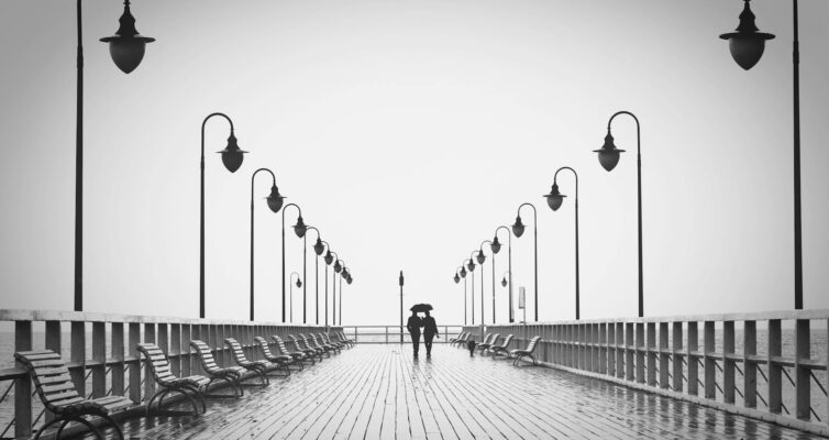 two people walking on pier