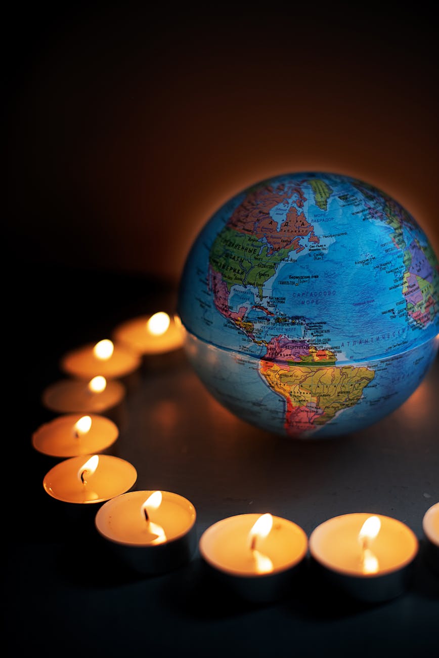 round globe surrounded with candles