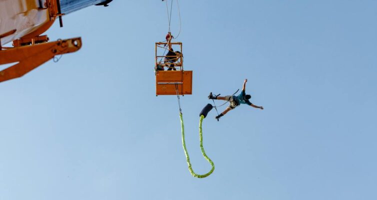 low angle shot of man bungee jumping