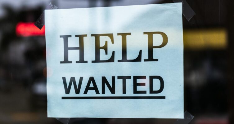 help wanted sign on glass